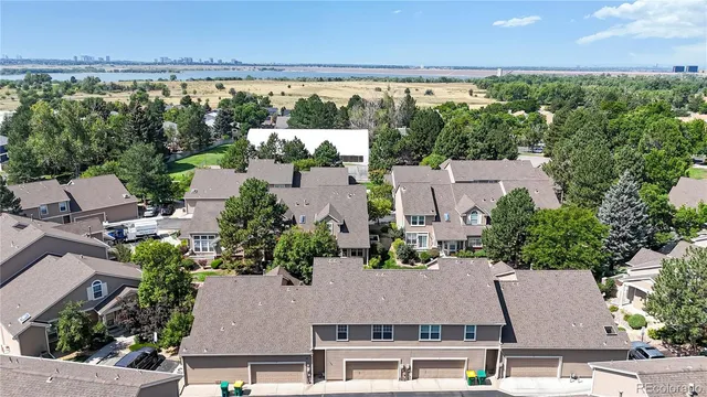 an aerial view of residential houses with outdoor space and street view