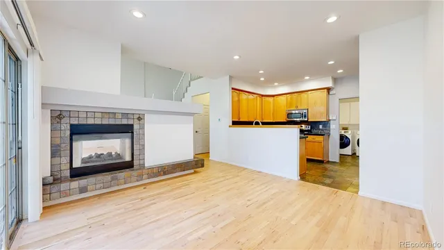 a view of a kitchen with a sink and a fireplace