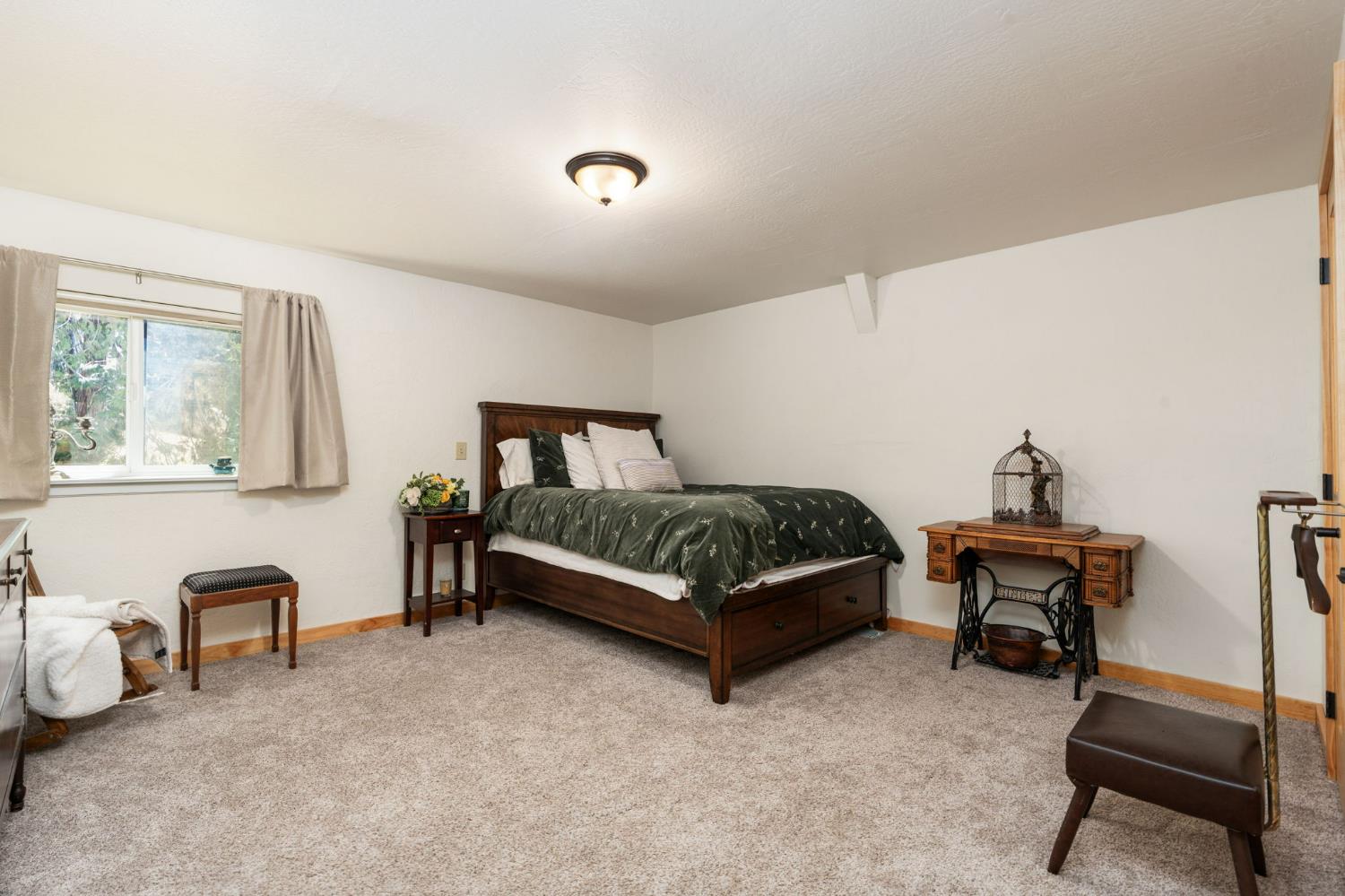 38303 Woodland Road Shaver Lake, CA 93664 - Photo 16 of 28 a bedroom with a bed and a chair