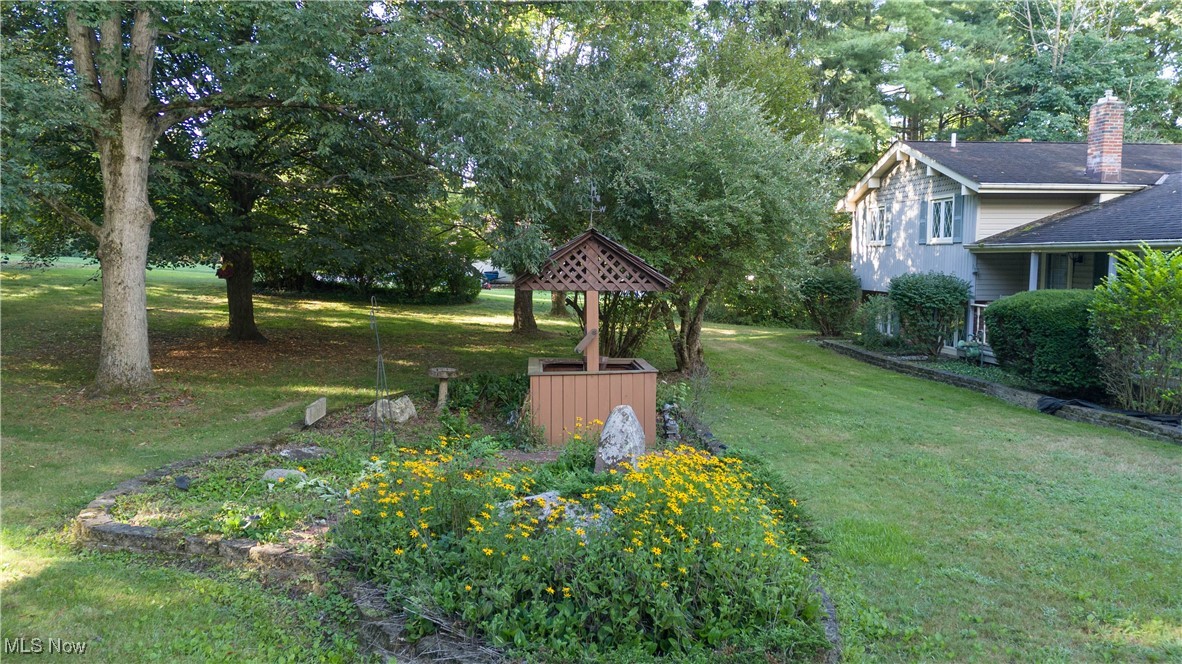 7840 Carter Road Northfield, OH 44067 - Photo 2 of 15 View of green lawn featuring view of wooded area
