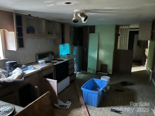 513 Boss Moore Road Ellenboro, NC 28040 - Photo 3 of 9 a kitchen with stainless steel appliances kitchen island granite countertop a refrigerator a stove and a sink