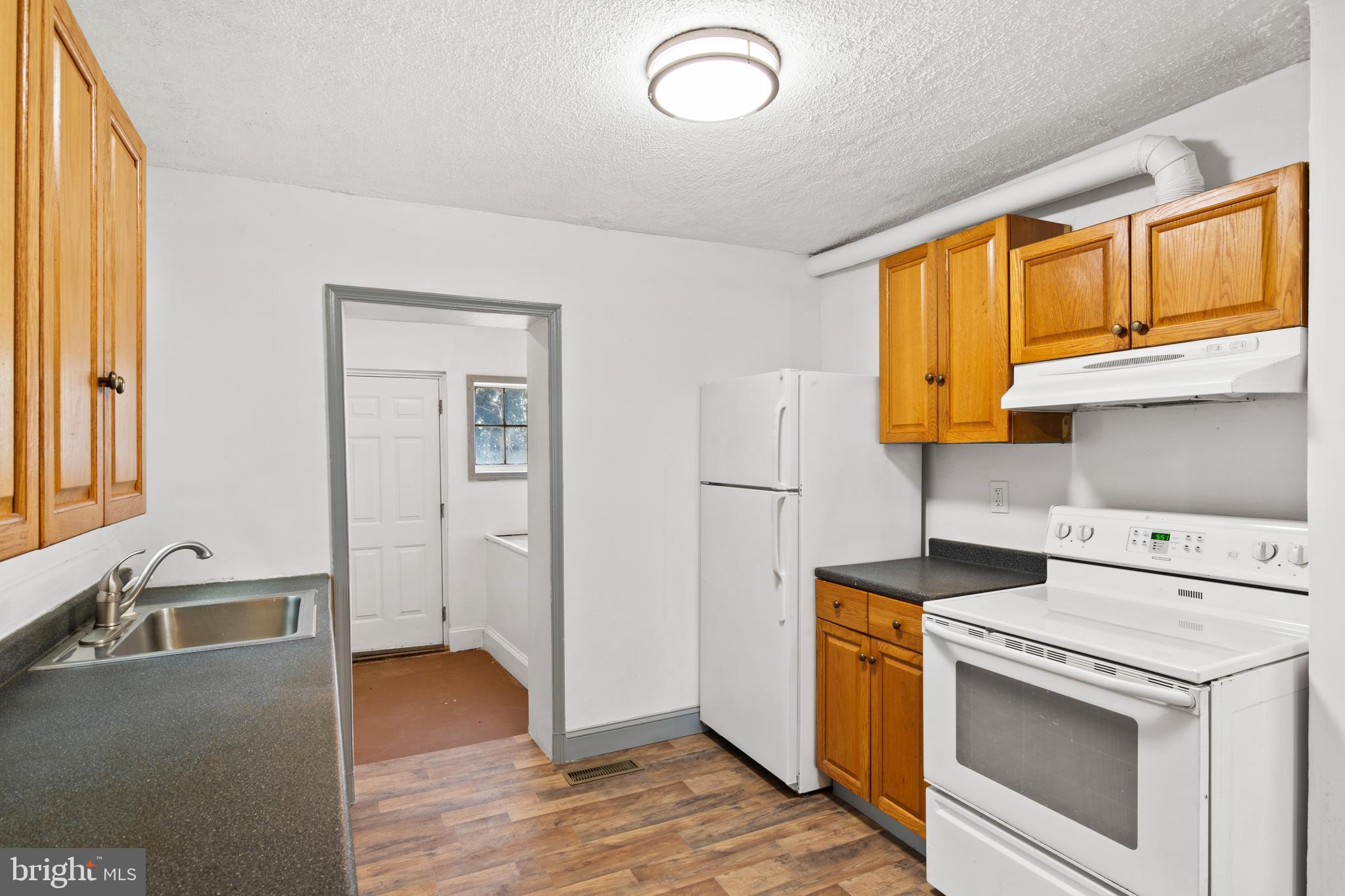 941 Brunswick Street Baltimore, MD 21223 - Photo 13 of 35 a view of a kitchen with wooden floor and electronic appliances