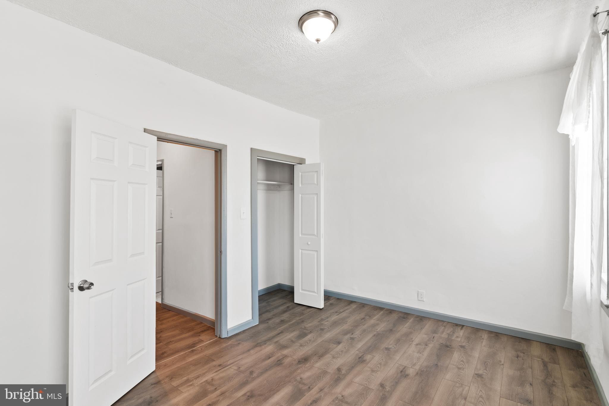 941 Brunswick Street Baltimore, MD 21223 - Photo 19 of 35 a view of an empty room with wooden floor