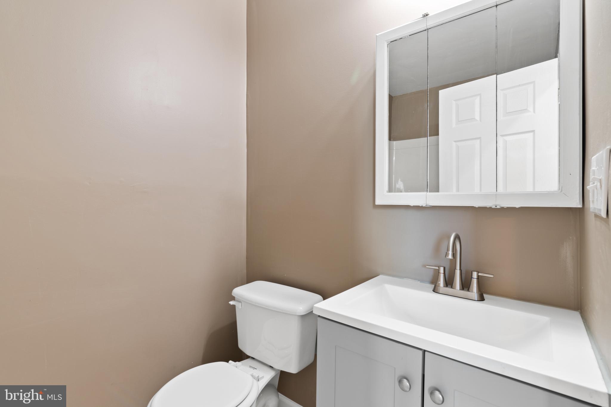 941 Brunswick Street Baltimore, MD 21223 - Photo 20 of 35 a bathroom with a sink a toilet and a vanity