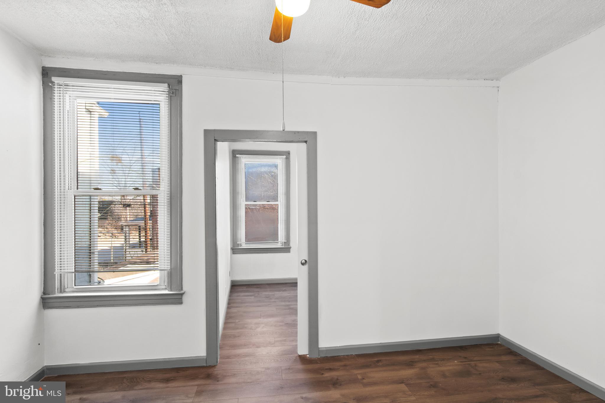 941 Brunswick Street Baltimore, MD 21223 - Photo 21 of 35 a view of a livingroom with wooden floor and a window