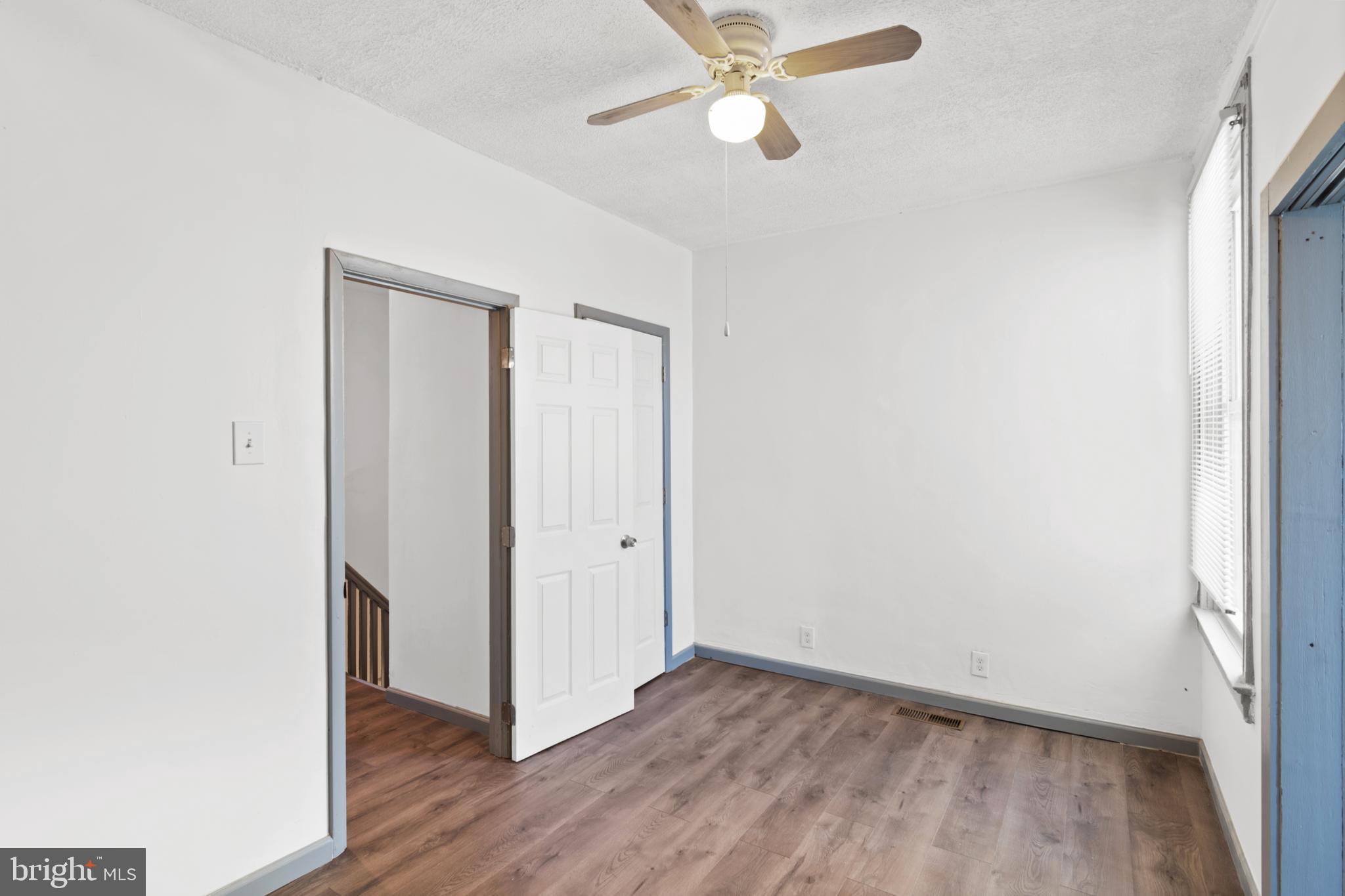 941 Brunswick Street Baltimore, MD 21223 - Photo 22 of 35 a view of an empty room with wooden floor