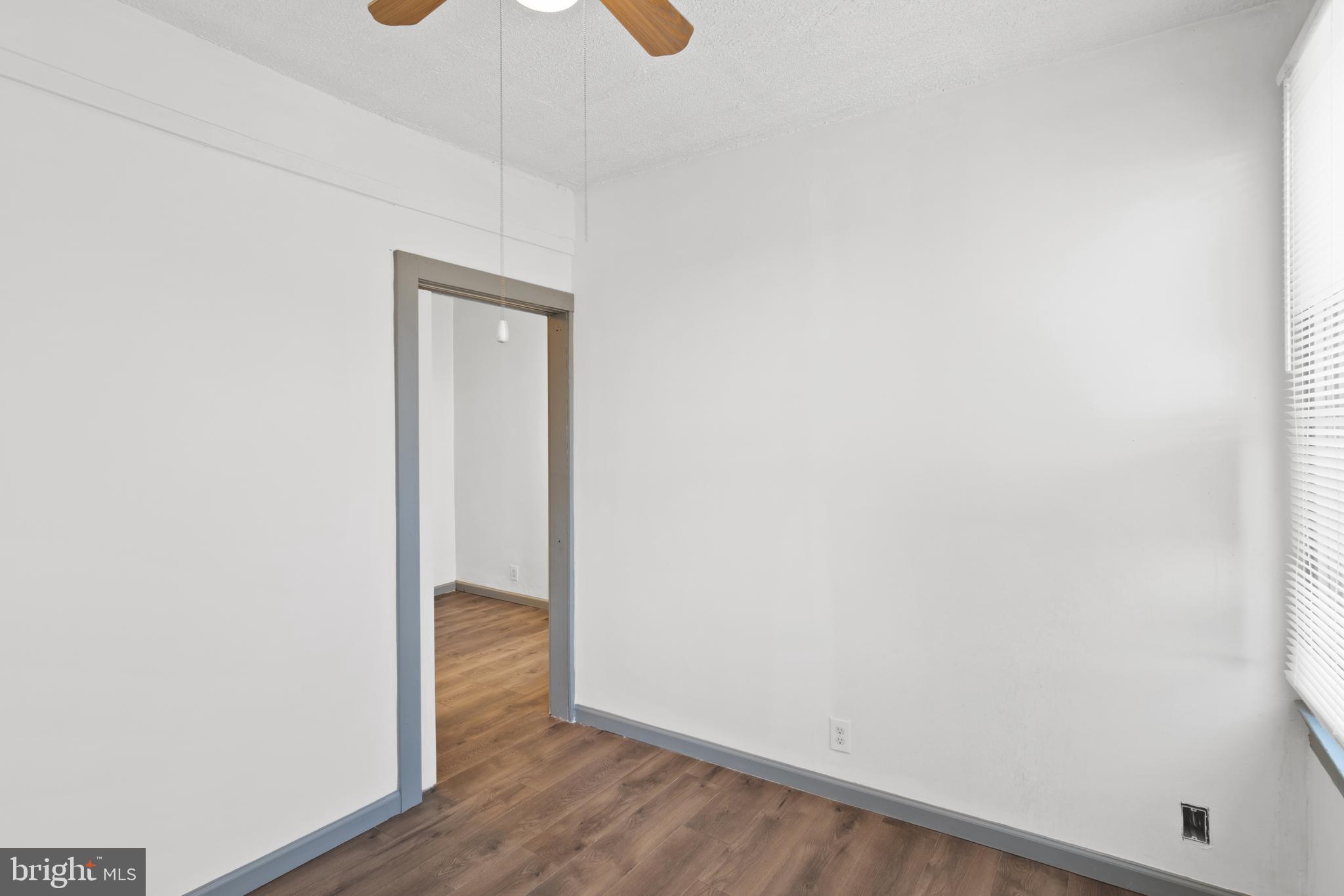 941 Brunswick Street Baltimore, MD 21223 - Photo 25 of 35 a view of an empty room with wooden floor
