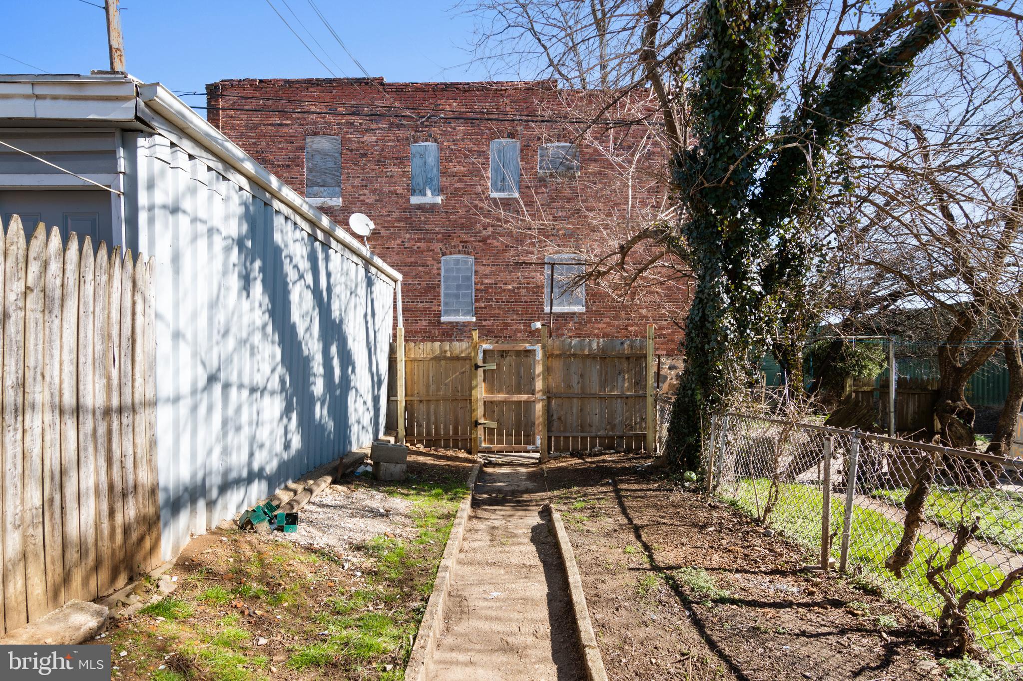 941 Brunswick Street Baltimore, MD 21223 - Photo 27 of 35 a view of backyard with brick wall and potted plants