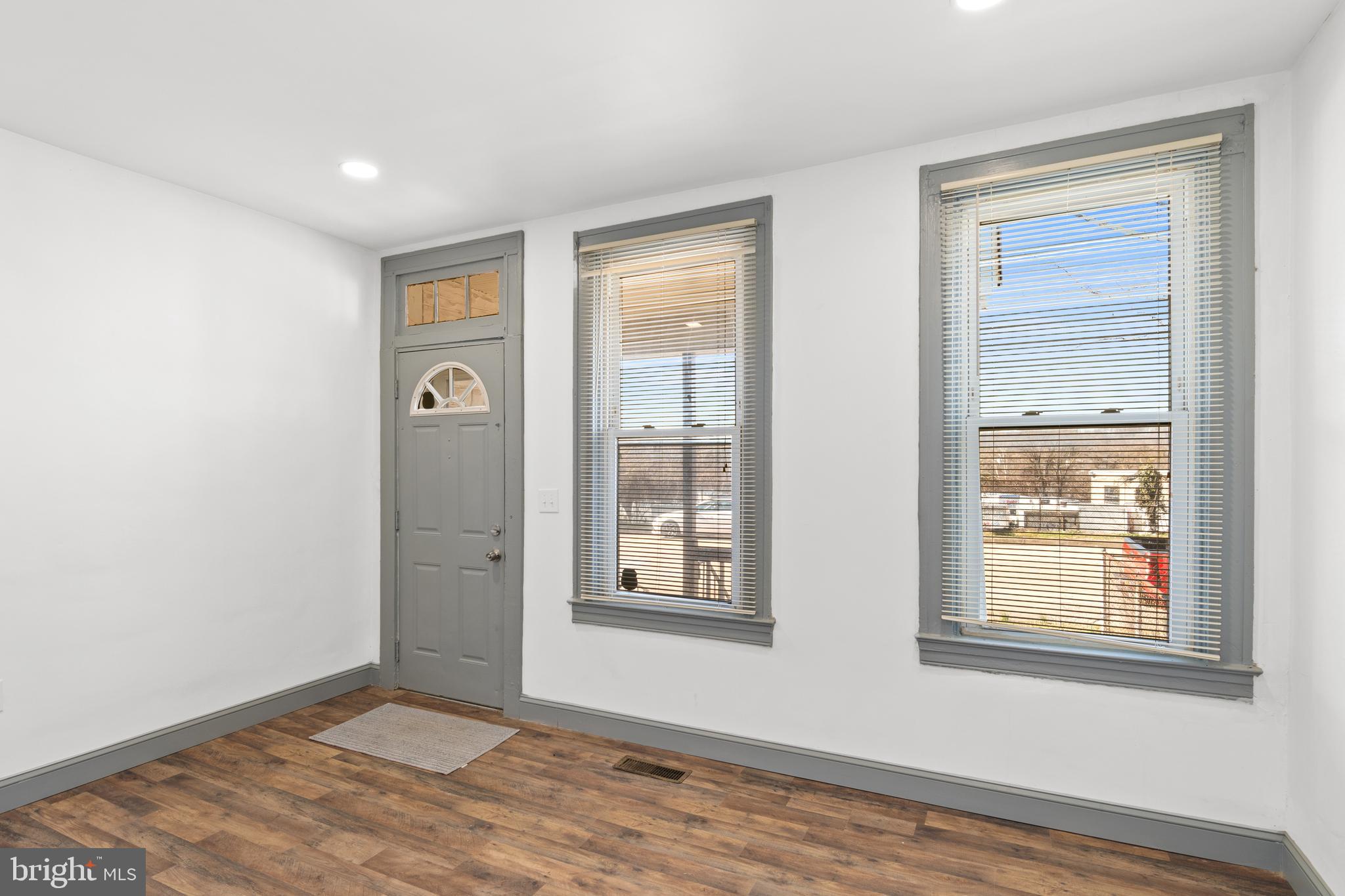 941 Brunswick Street Baltimore, MD 21223 - Photo 3 of 35 a view of an empty room with window and wooden floor