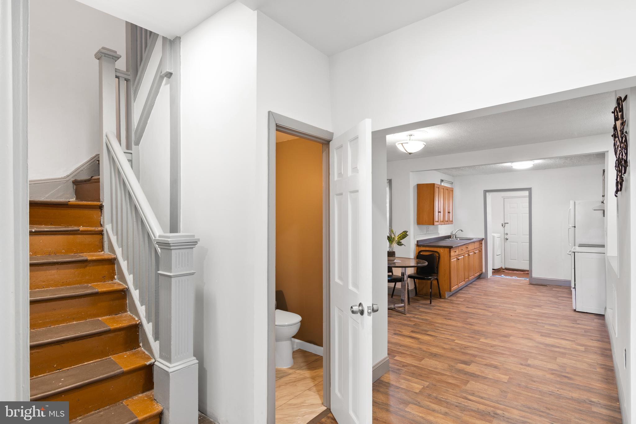 941 Brunswick Street Baltimore, MD 21223 - Photo 6 of 35 a view of a hallway with wooden floor and staircase
