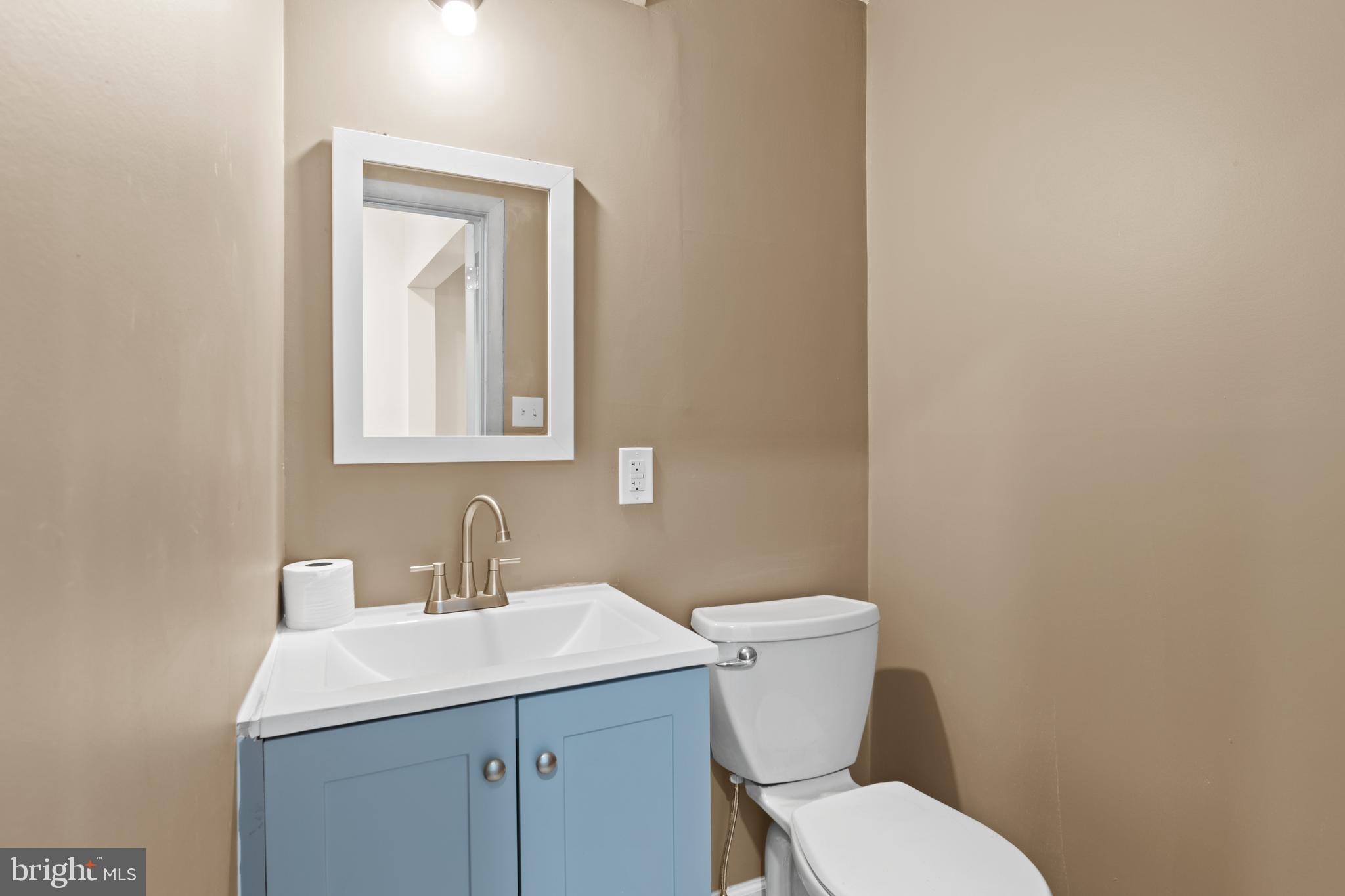 941 Brunswick Street Baltimore, MD 21223 - Photo 7 of 35 a bathroom with a toilet sink and mirror