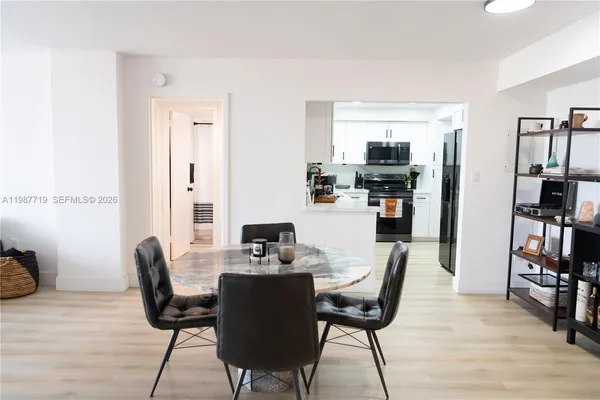 a dining room with furniture and wooden floor