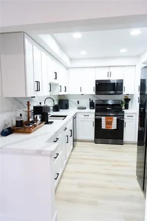 a kitchen with stainless steel appliances a stove sink and cabinets
