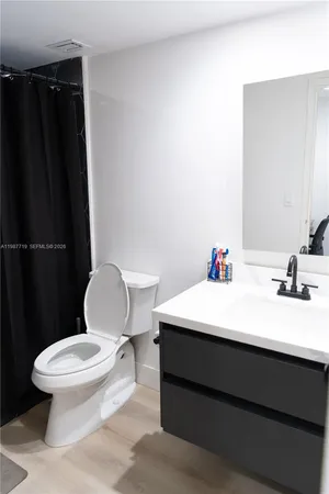 a white toilet sitting next to a bathroom sink