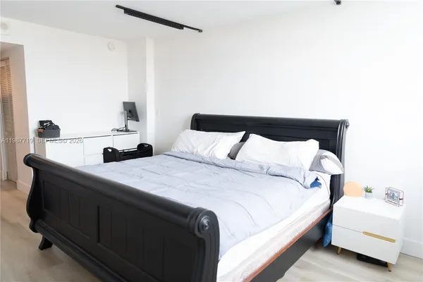 a bedroom with a bed and a potted plant