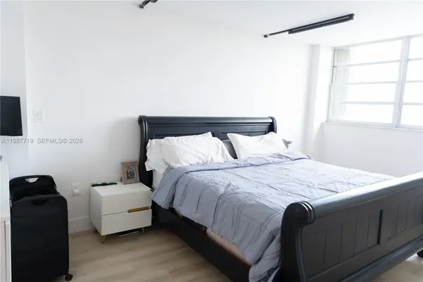 a bedroom with a bed and a couch