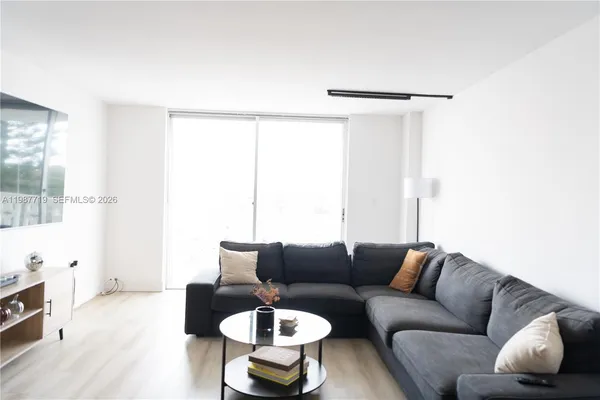 a living room with furniture and a large window