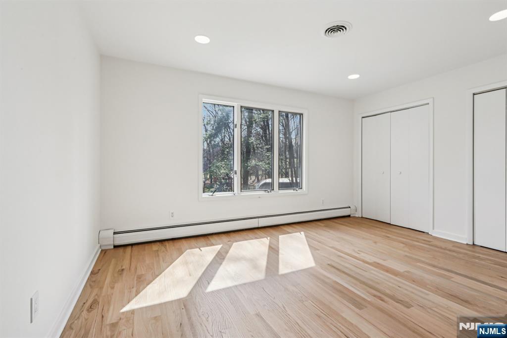 11 Carlough Road Upper Saddle River, NJ 07458 - Photo 35 of 41 an empty room with wooden floor and windows