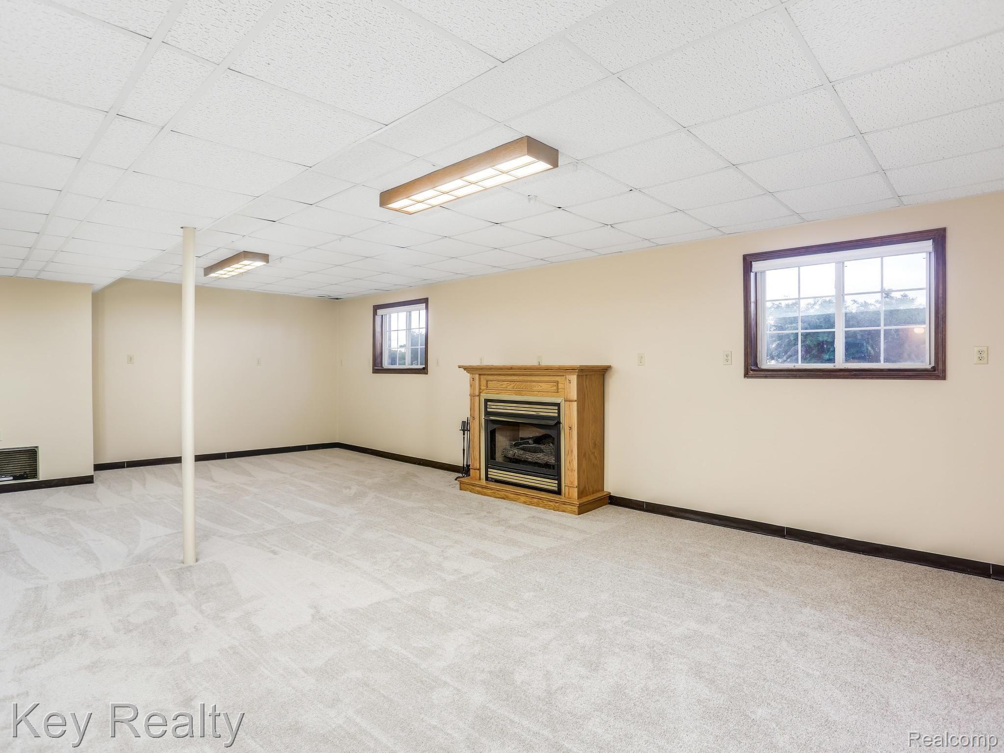 4048 Morrish Road Swartz Creek, MI 48473 - Photo 29 of 40 Lower level great room with fireplace.