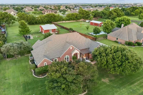 an aerial view of a house with garden space and street view