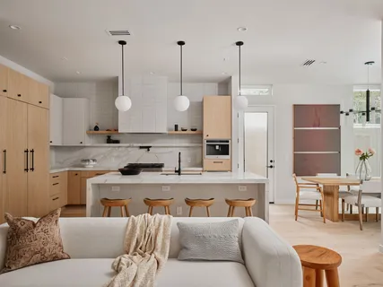 a living room with furniture a table and chairs