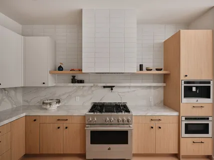 a kitchen with granite countertop a stove sink and cabinets