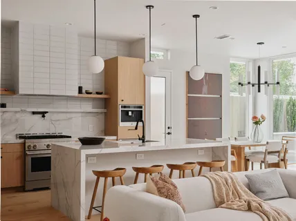 a kitchen with stainless steel appliances granite countertop a refrigerator a sink and a stove