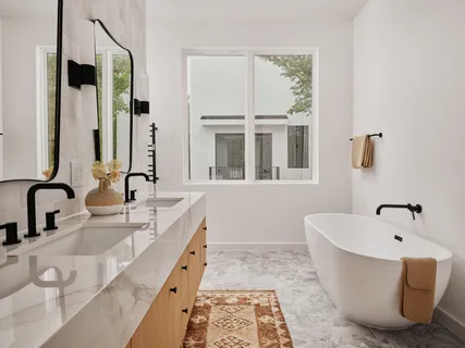 a bathroom with a tub sink and mirror