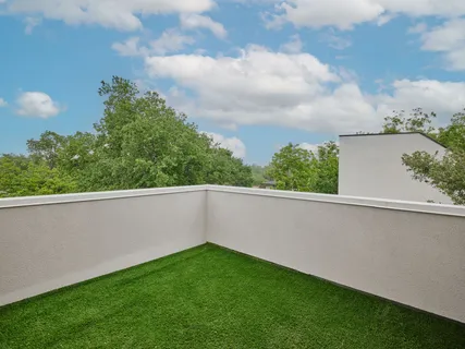 a view of backyard with swimming pool and seating space