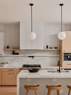 a kitchen with stainless steel appliances granite countertop a sink a stove and white cabinets