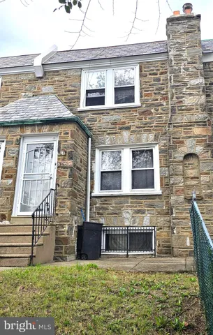 a view of a brick house with a yard and a table