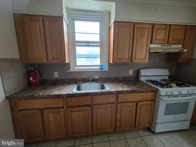 a kitchen with granite countertop a sink stainless steel appliances and cabinets