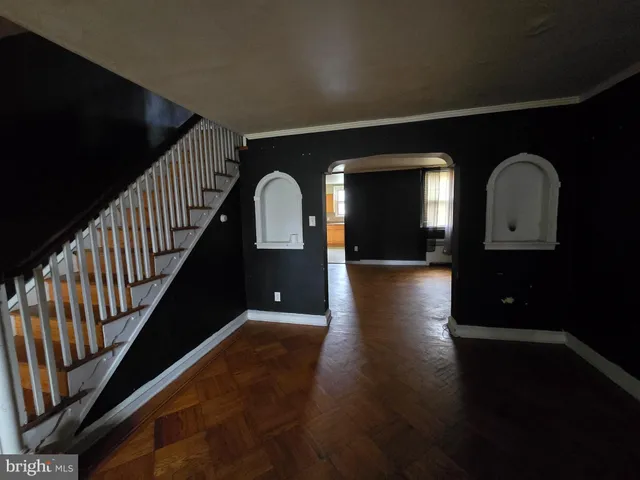 a view of entryway and hall with wooden floor