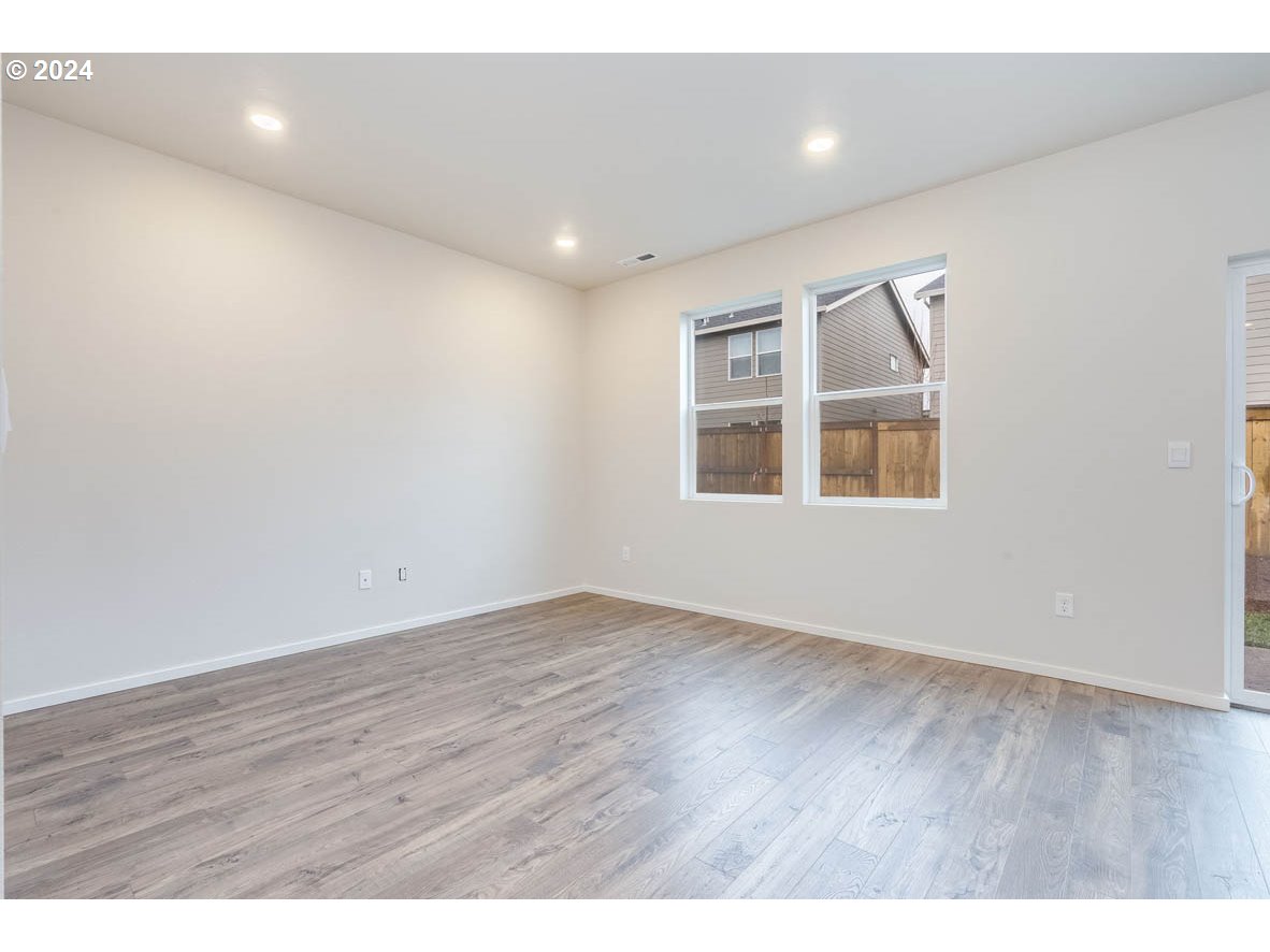 2998 U Street Springfield, OR 97477 - Photo 6 of 16 an empty room with wooden floor and windows