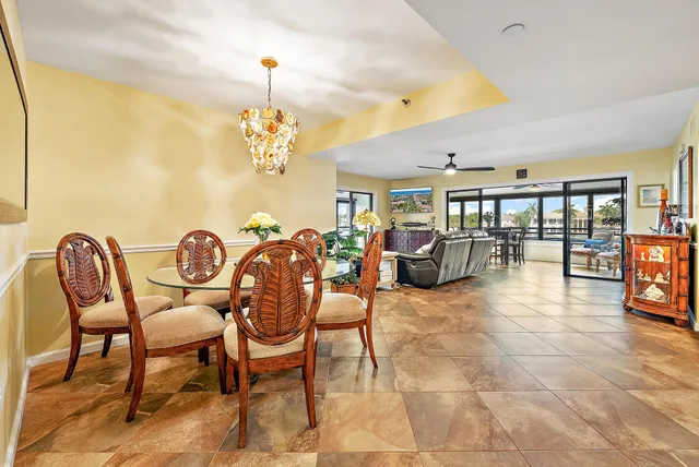 a dining room with furniture and a chandelier