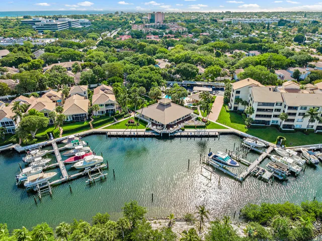 an aerial view of a house with a garden and lake view