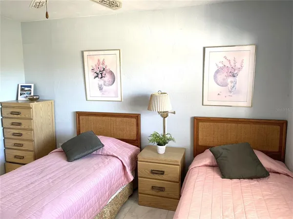 a bedroom with a bed and a painting on the wall
