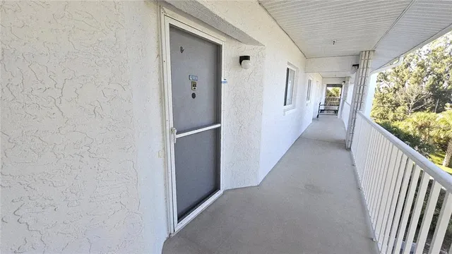 a view of hallway with wooden floor and stairs
