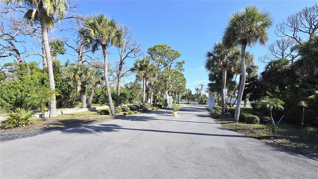 1401 South McCall Road, Unit 301A Englewood, FL 34223 - Photo 3 of 22 a backyard of a house with lots of green space
