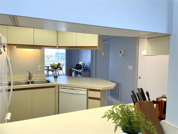 a kitchen with stainless steel appliances a sink a counter top space
