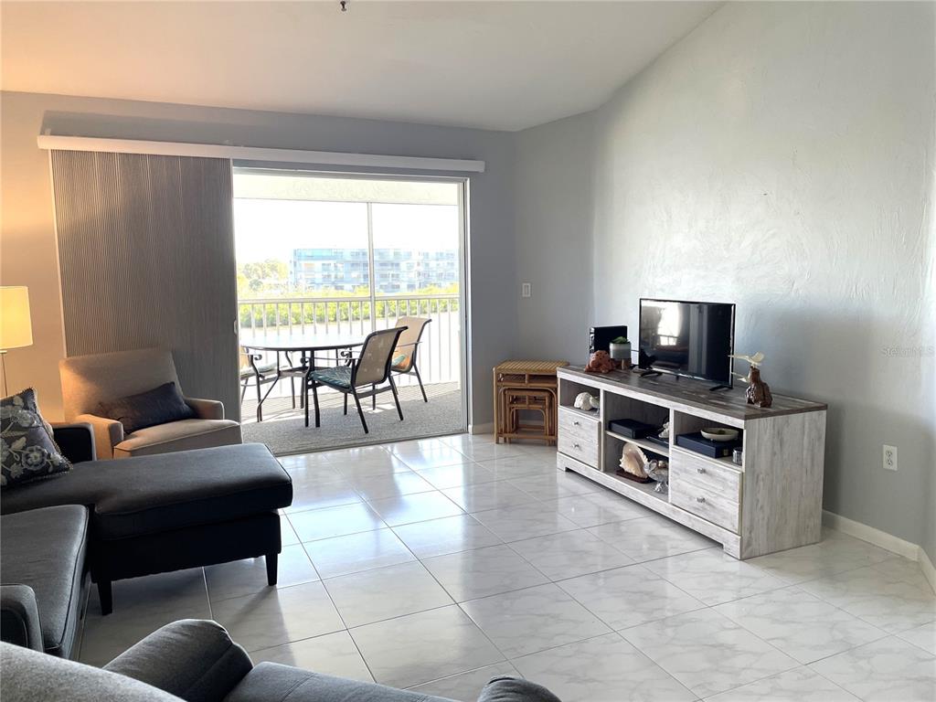 1401 South McCall Road, Unit 301A Englewood, FL 34223 - Photo 9 of 22 a living room with furniture and a flat screen tv