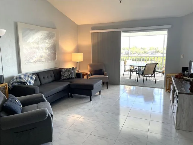 a living room with furniture and a large window