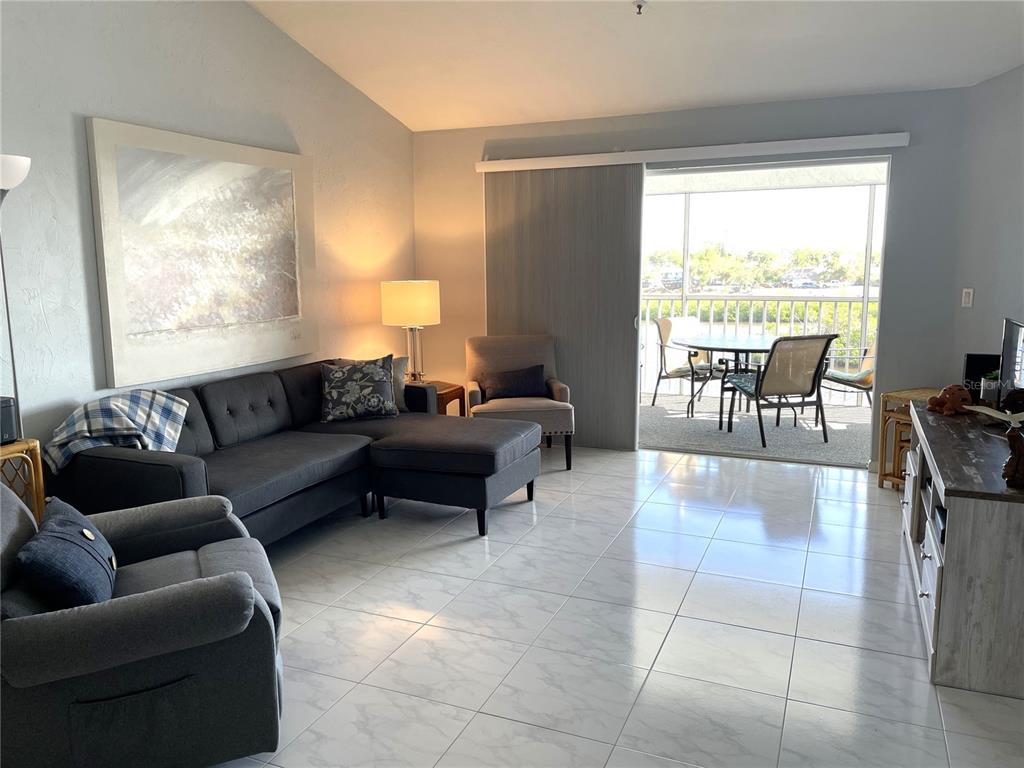 1401 South McCall Road, Unit 301A Englewood, FL 34223 - Photo 10 of 22 a living room with furniture and a large window