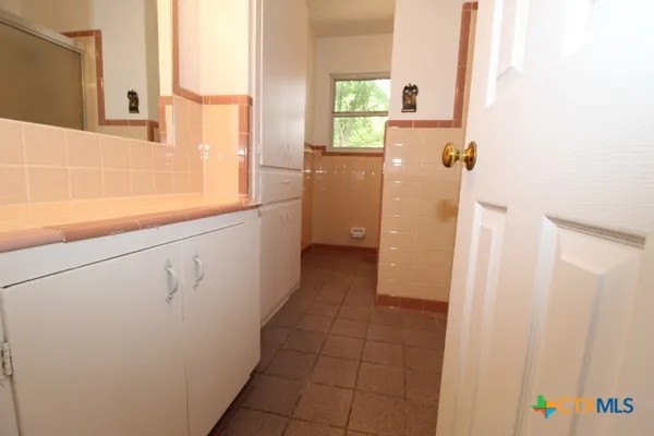 a bathroom with a sink a toilet and a shower