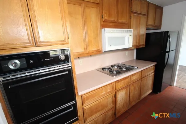 a kitchen with granite countertop cabinets and steel stainless steel appliances