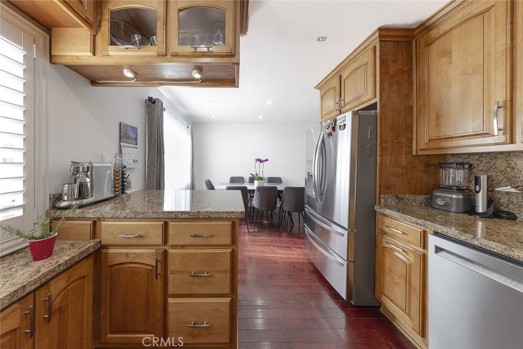 9775 Vía Roma Burbank, CA 91504 - Photo 13 of 39 a kitchen with cabinets wooden floor and stainless steel appliances