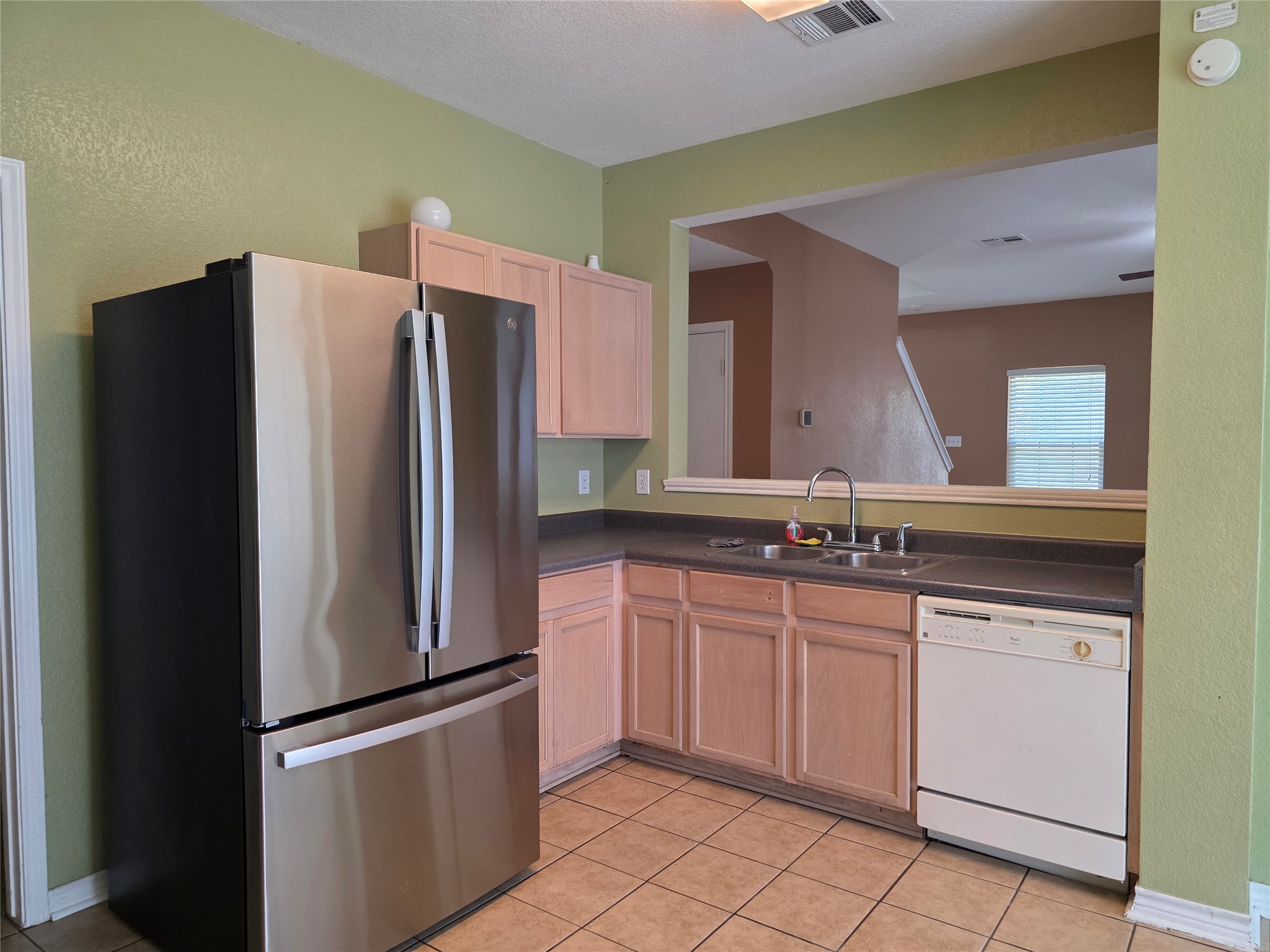 189 Ruidoso Road Kyle, TX 78640 - Photo 11 of 31 Well-equipped kitchen features ample cabinet storage and a pass-through window to the adjacent living space.