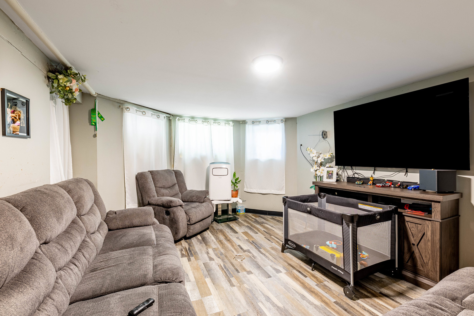 2434 South Harding Avenue Chicago, IL 60623 - Photo 13 of 21 a living room with furniture and a flat screen tv