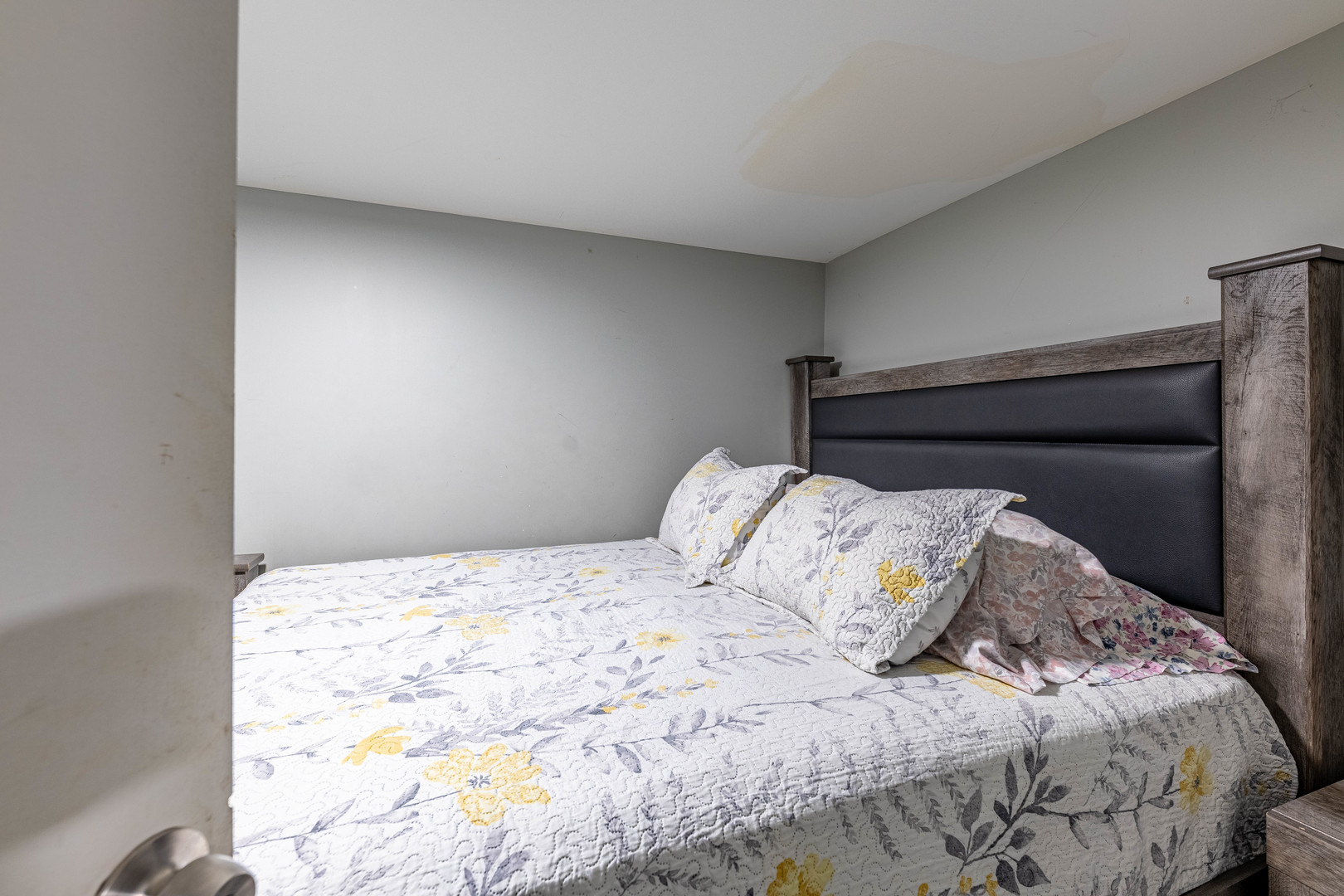 2434 South Harding Avenue Chicago, IL 60623 - Photo 15 of 21 a bed with a white comforter and pillows