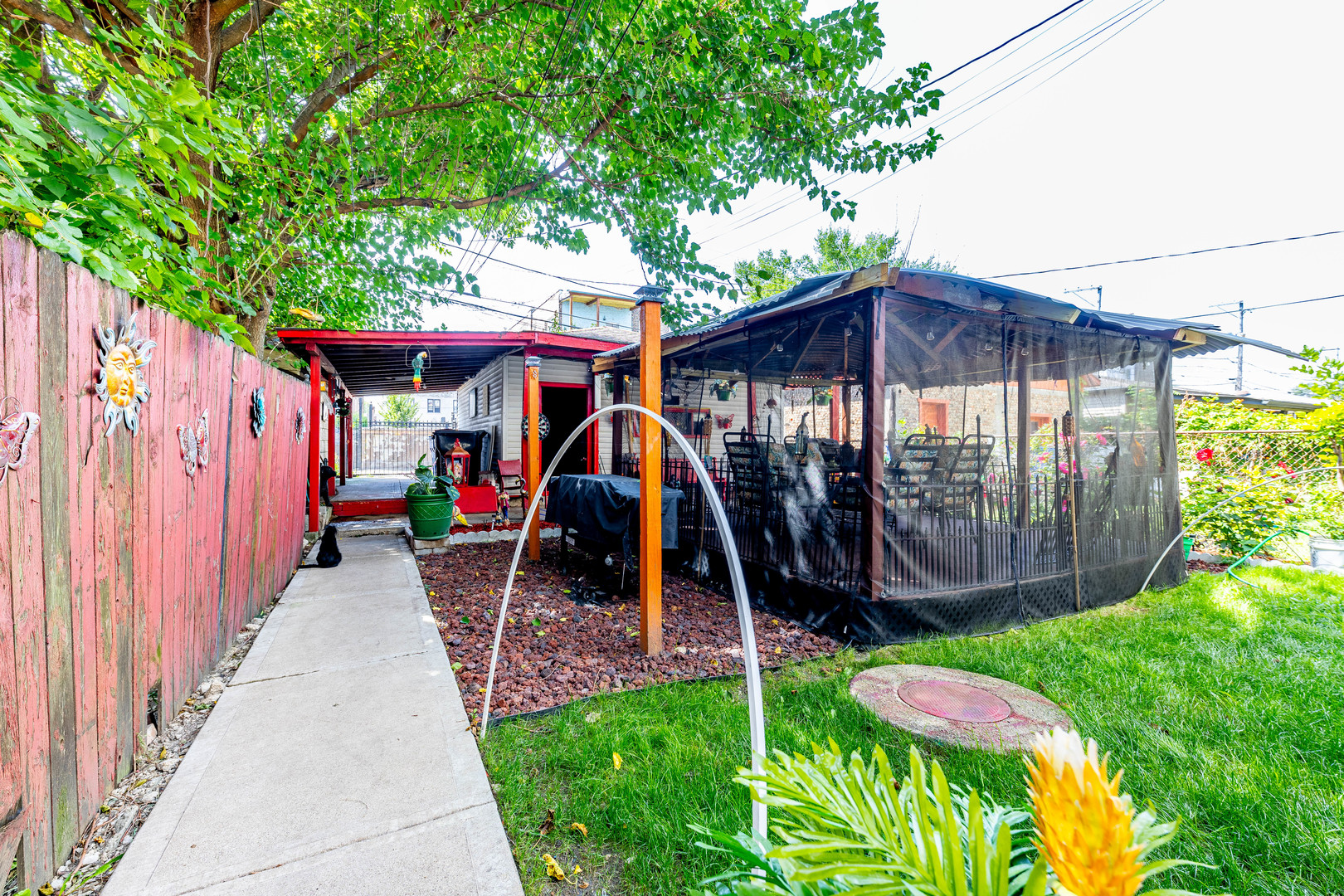 2434 South Harding Avenue Chicago, IL 60623 - Photo 20 of 21 a view of a wooden house with a big yard and potted plants